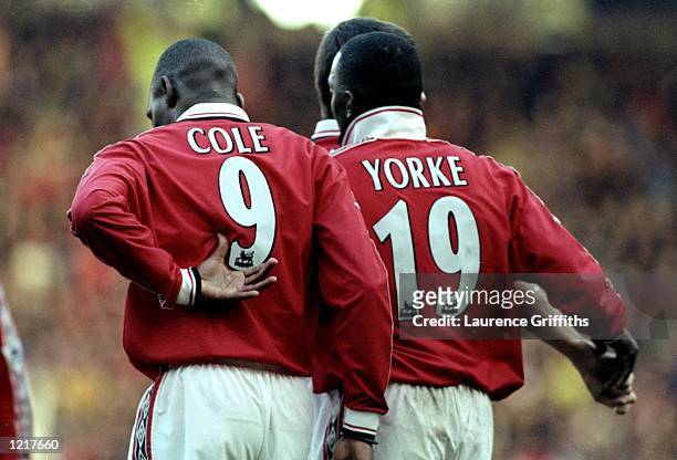 Dwight Yorke and Andy Cole of Manchester United celebrate a goal together during the FA Carling Premiership match against Southampton played at Old...