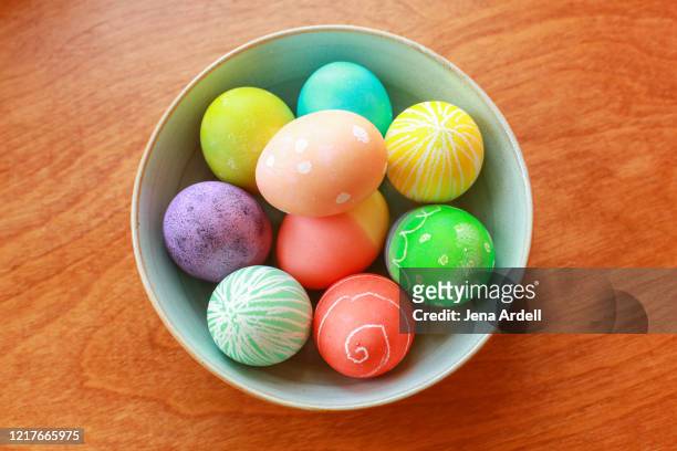 bowl of colorful easter eggs - hard boiled eggs stock-fotos und bilder