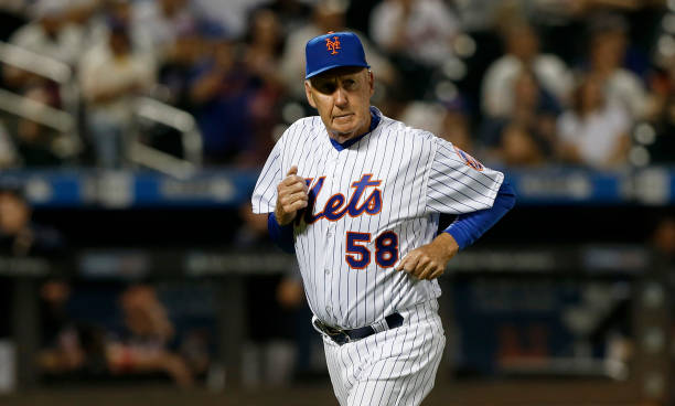 Pitching coach Phil Regan of the New York Mets runs back to the dugout during the eighth inning against the Atlanta Braves at Citi Field on Friday,...