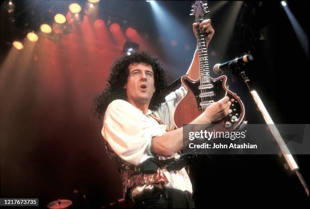 Astrophysicist and musician Brian May, most widely known as the lead guitarist of the rock band Queen, is shown performing on stage during a concert...