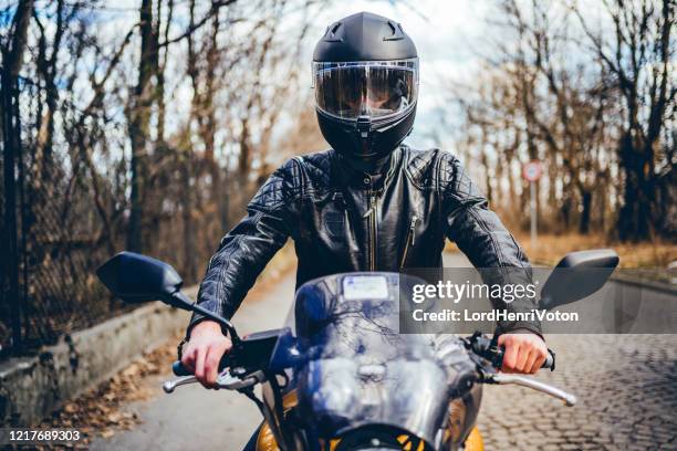 man riding a motorbike - motorcycle biker stock pictures, royalty-free photos & images