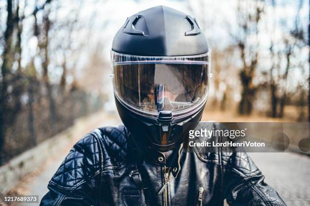 man with helmet on motorcycle - sports helmet stock pictures, royalty-free photos & images