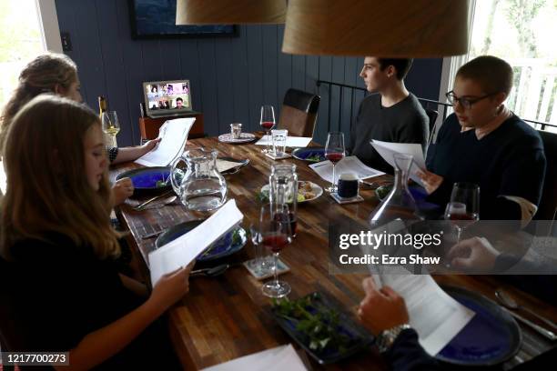 Sarah and Aaron Sanders celebrate a Passover Seder with their children, Noah Bella, 18 and Maya at home and different family members across the...