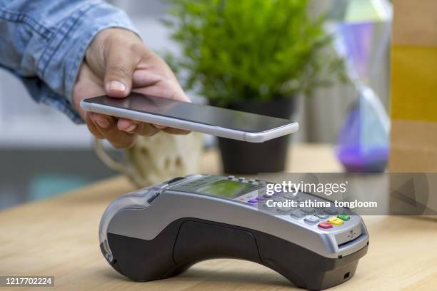 contactless payment by mobile phone with qr code - customers pay with contactless cards stock pictures, royalty-free photos & images