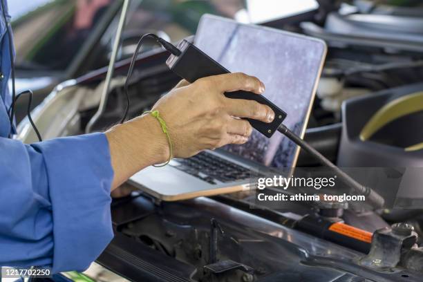hand of car mechanic and tool, mechanic fixing a car engine - auto repair shop background stock pictures, royalty-free photos & images