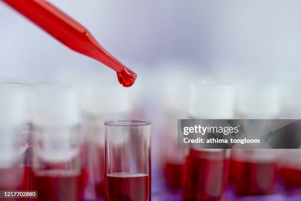 lab test,equipment and glassware for test product extraction and red colour solution, in the chemistry laboratory - blood cancer stock pictures, royalty-free photos & images