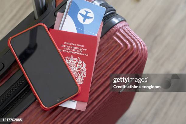 passport ,ticket and mobile phone on red suitcase . travel concept - airplane tickets stock pictures, royalty-free photos & images