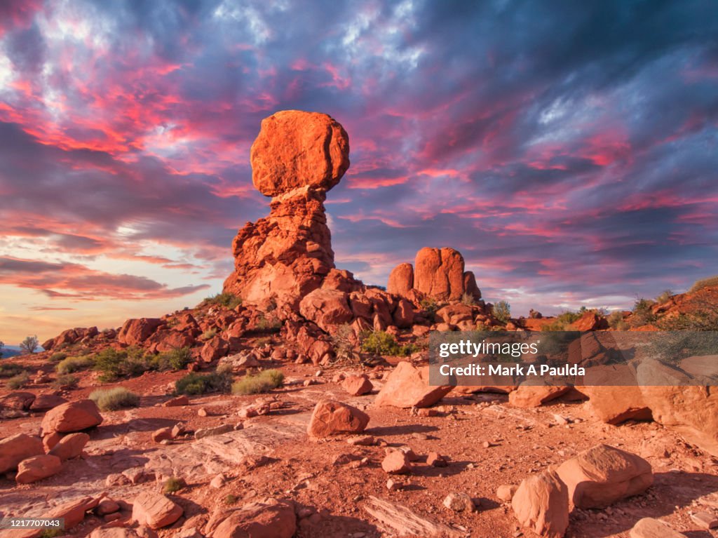 Desert Landscape With Balanced Rock During Dramatic Sunset