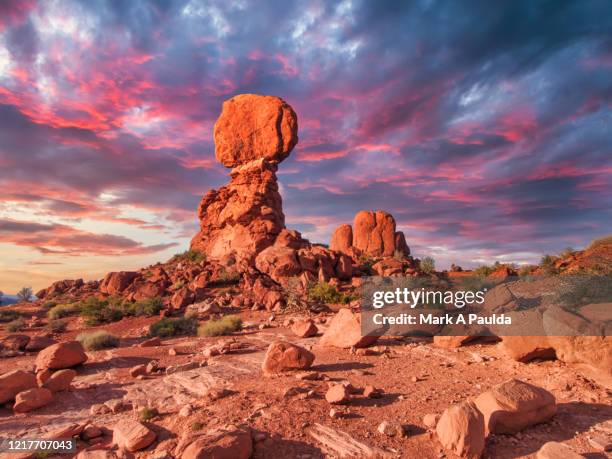 desert landscape with balanced rock during dramatic sunset - arches-national-park stockfoto's en -beelden