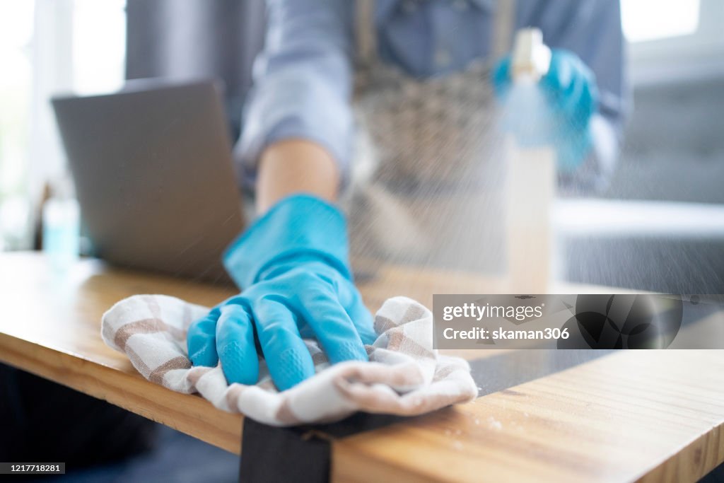 Asian female housekeeping cleaning remote  and cleanning knob and home for stop Covid-19 (coronavirus) Coronavirus outbreak or Covid-19, Concept of Covid-19 quarantine