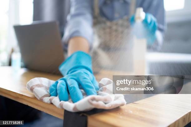 asian female housekeeping cleaning remote  and cleanning knob and home for stop covid-19 (coronavirus) coronavirus outbreak or covid-19, concept of covid-19 quarantine - desinfetar imagens e fotografias de stock