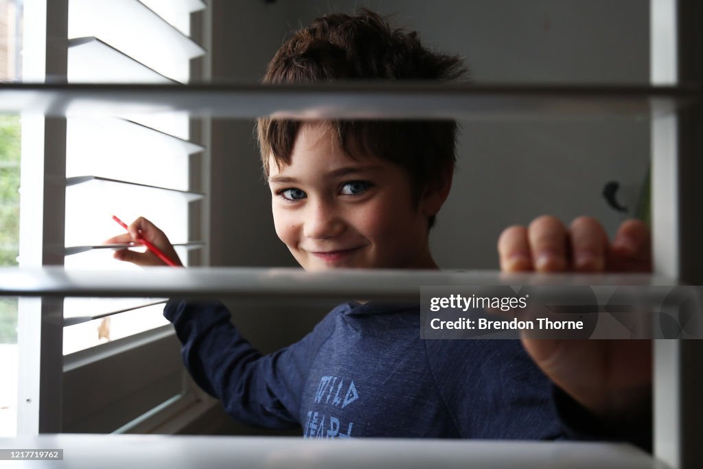 Phoenix Crawford takes a break from school work at home on April 09