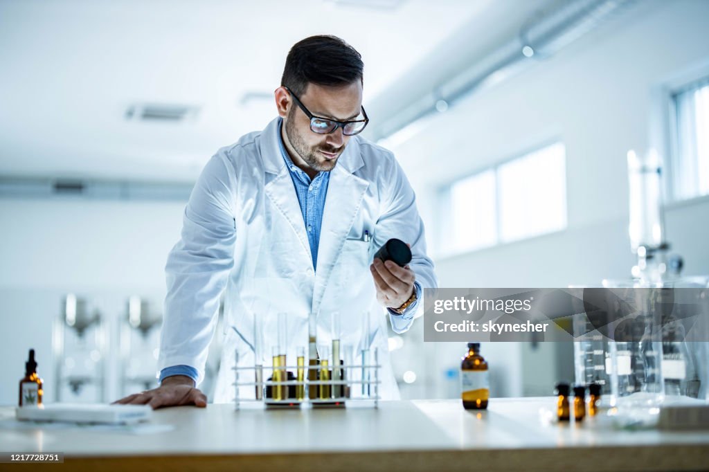 Young medical expert working on a virus medicine in laboratory.