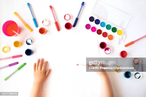 close up of child's hands drawing at white paper. - baby paint stock-fotos und bilder