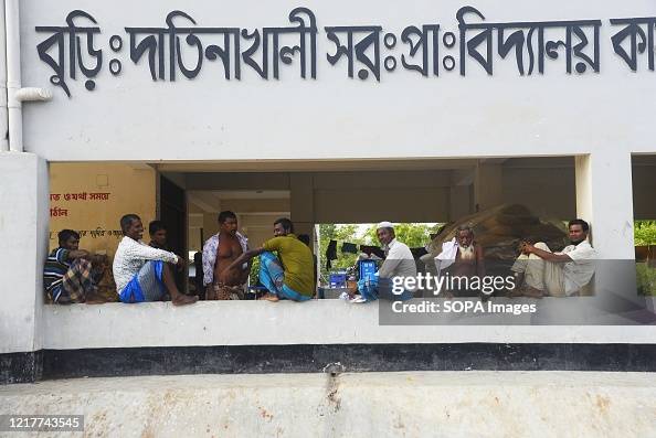 People take refugee on top of a cyclone relief shelter as...