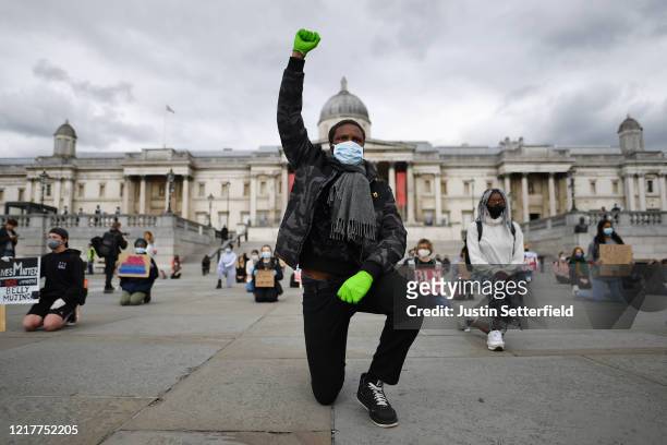 Protesters kneel in Trafalgar Square during a Black Lives Matter demonstration on June 5, 2020 in London, United Kingdom. The death of an...