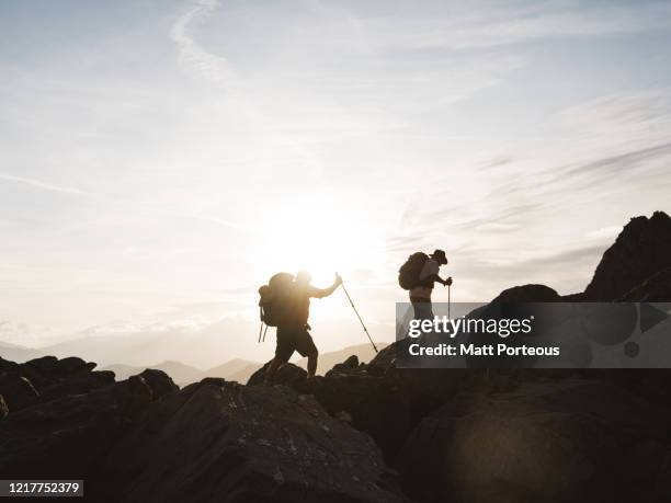 silhouette of two senior mountain hikers - central eastern alps stock pictures, royalty-free photos & images