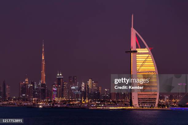 dubai skyline at night - burj al arab night stock pictures, royalty-free photos & images