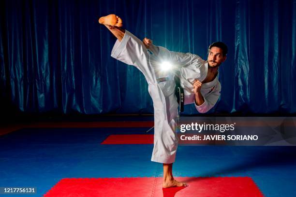 Spanish karate athlete Damian Quintero, world champion in Karate Kata and qualified for the Olympics 2021, performs a kata as he poses for an AFP...