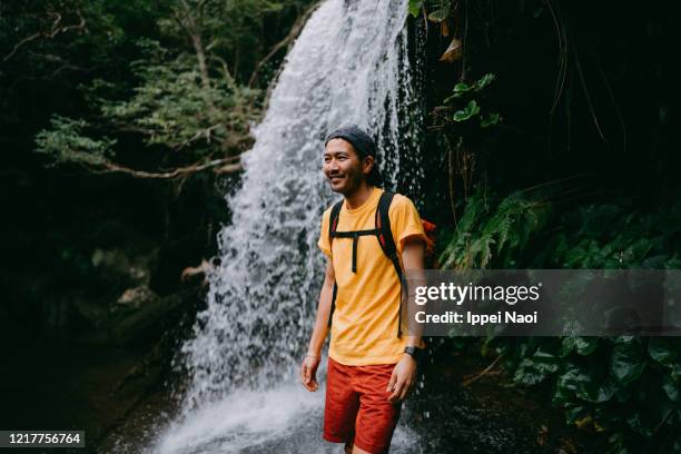 japanese man hiking in front of waterfall - アウトドア　日本人 ストックフォトと画像