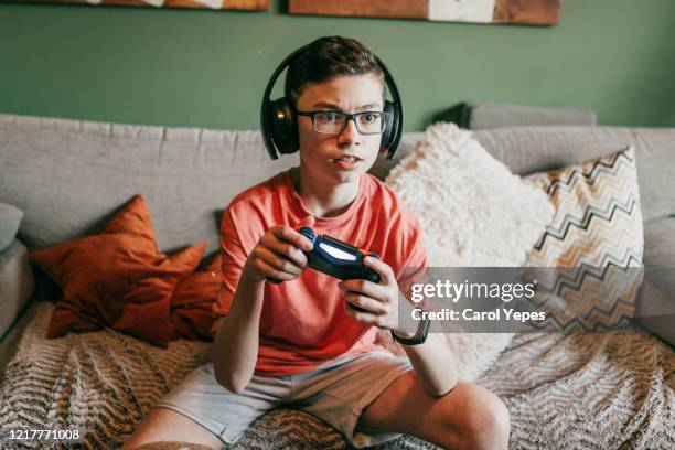 gamer teeenager boy - teenage boy playing playstation stock pictures, royalty-free photos & images