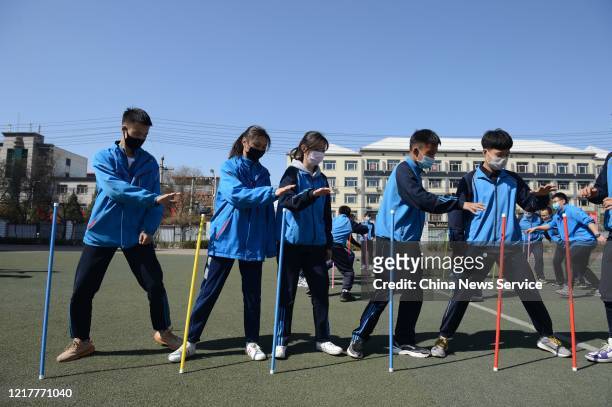 Students of Hohhot No.26 Middle School play a game during a mental health course to relieve stress on April 9, 2020 in Hohhot, Inner Mongolia...