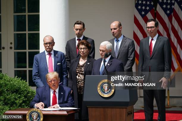 President Donald Trump speaks while signing the Paycheck Protection Program Flexibility Act of 2020, as he holds a press conference on the economy,...