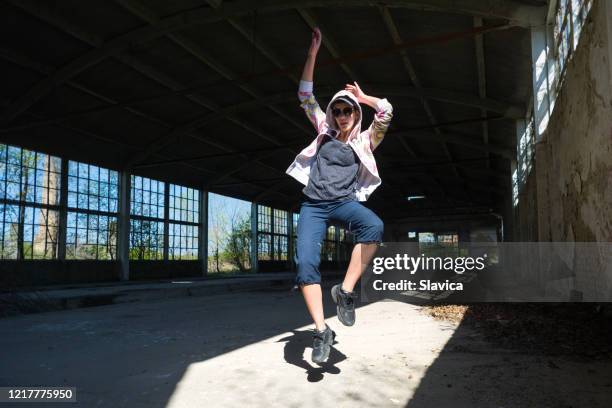 hip hop female dancer dancing in abandoned building - hip hopper stock pictures, royalty-free photos & images