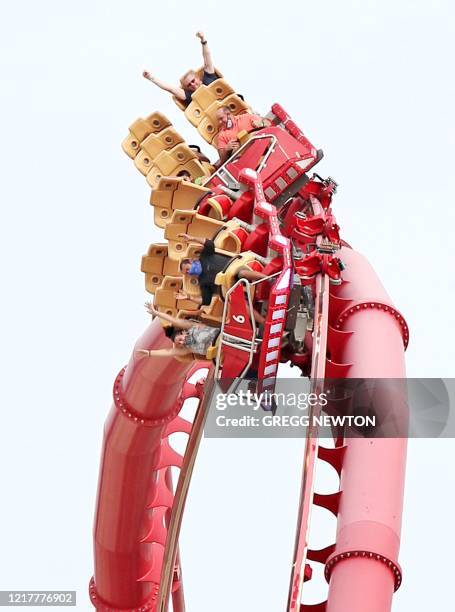 Visitors ride the Hollywood Rip Ride Rockit roller coaster at Universal Studios theme park on the first day of reopening from the coronavirus...