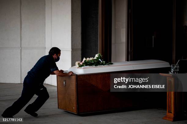 Worker pushes the coffin of Francia Nelly, from Ecuador, who died of complications related to coronavirus disease inside the crematory after her...