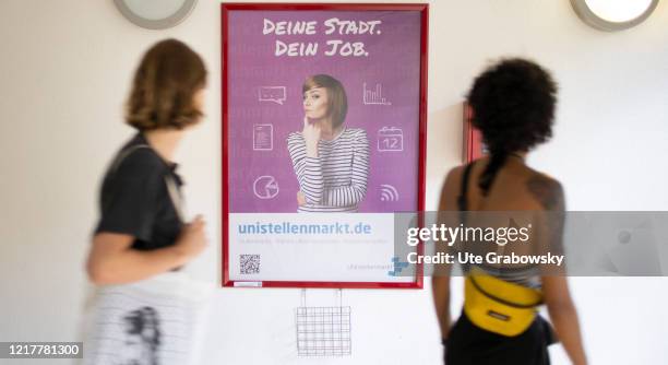 Side job wanted. Students in front of a poster with the message: your city, your job in times of corona pandemic on May 29, 2020 in Bonn, Germany.