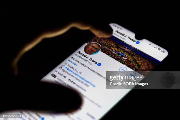 In this photo illustration the official page of the President of the United States, Donald Trump on Twitter seen displayed on a smartphone.