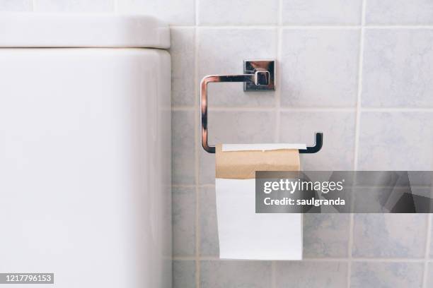 toilet paper roll about to run out - rolled up stockfoto's en -beelden