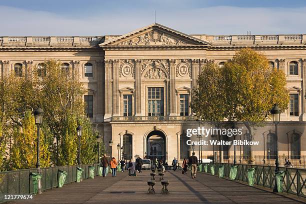 france, paris, pont des arts bridge and palais du louvre - place du louvre stock pictures, royalty-free photos & images