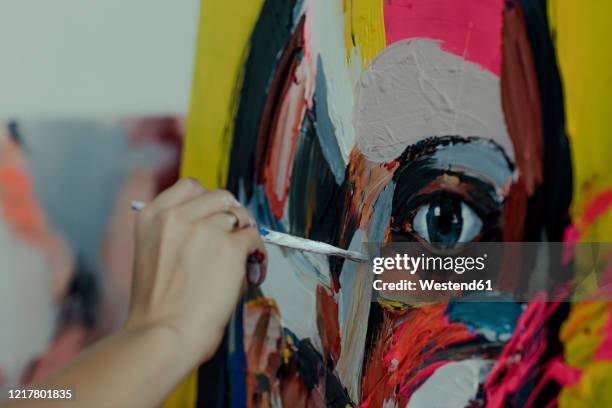 hand of a female painter painting in her studio - pittore artista foto e immagini stock