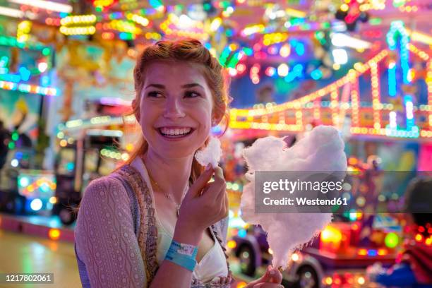 portrait of happy redheaded teenage girl with candy floss at beer fest - munich food stock pictures, royalty-free photos & images