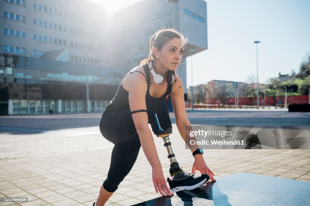 Portrait of sporty young woman with leg prosthesis in the city