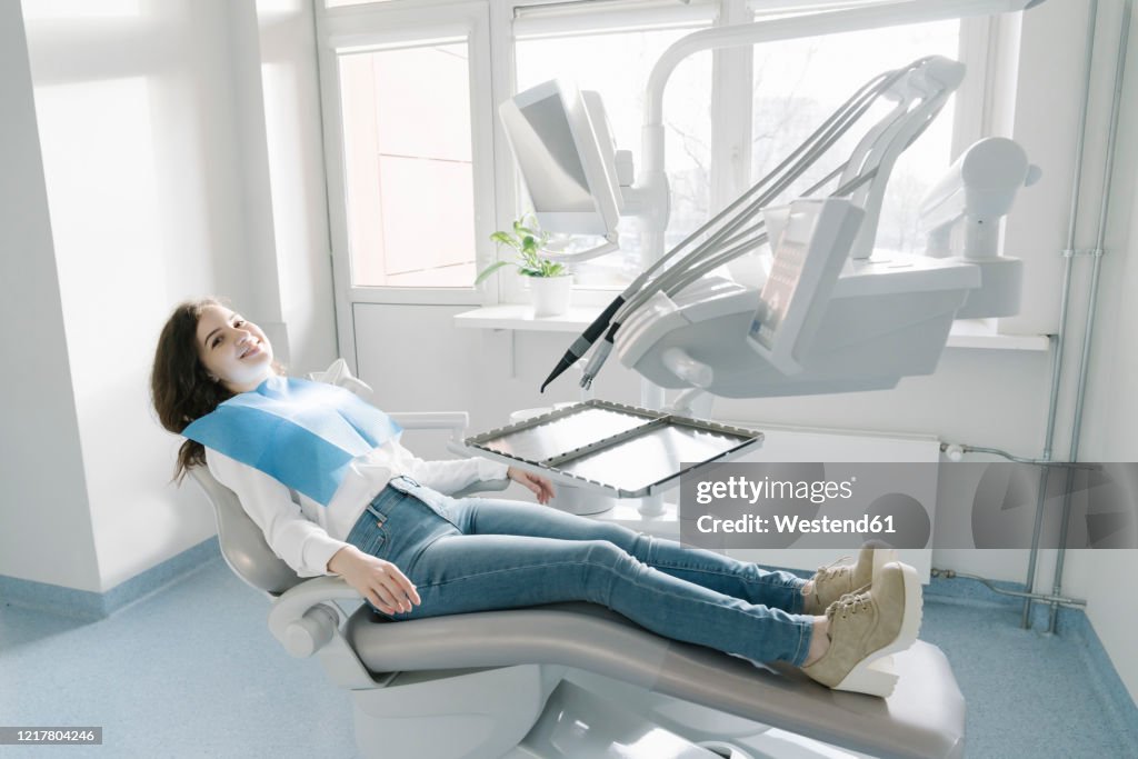 Confident young woman waiting for treatment in dental clinic