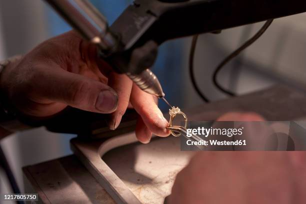 man working in a welding a diamond ring with a welding machine - jewelry maker stock pictures, royalty-free photos & images
