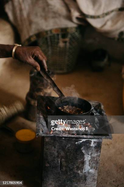 cropped image of woman preparing coffee during traditional ceremony, ethiopia, central tigray, mugulat - ethiopian coffee ceremony imagens e fotografias de stock