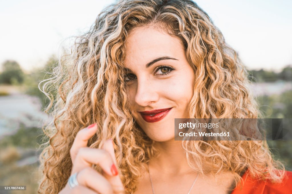 Portrait of blond young woman with red lips