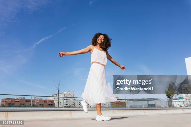 portrait of happy young woman dancing - running shoes sky stock pictures, royalty-free photos & images