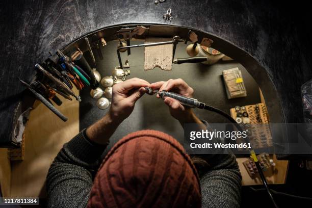 goldsmith working on ring in his workshop, from above - jewellery workshop ストックフォトと画像