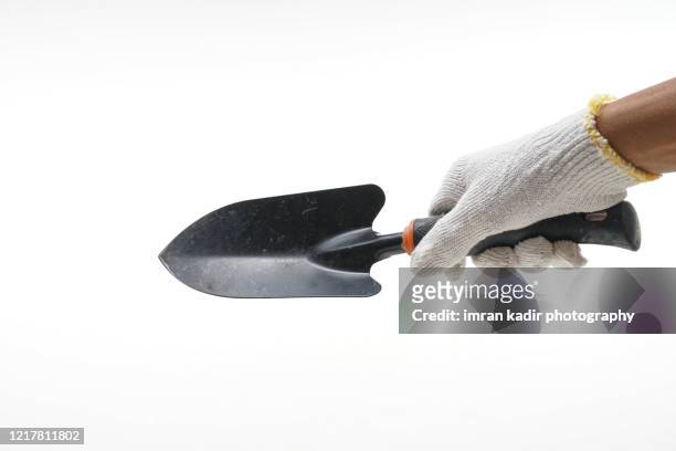 holding spanner on isolated white background. - truelle photos et images de collection