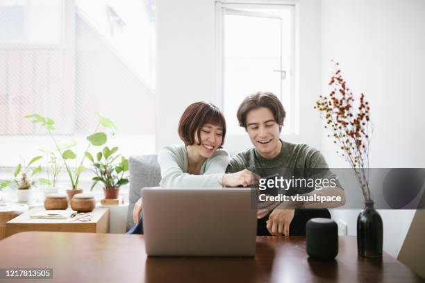couple using technology together - see stock pictures, royalty-free photos & images