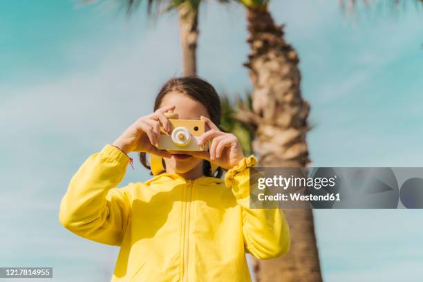 little girl taking photo with toy camera - toy camera stock pictures, royalty-free photos & images