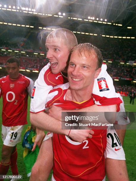 Philippe Senderos and Dennis Bergkamp of Arsenal celebrate after the FA Cup Final match between Arsenal and Manchester United on May 21, 2005 in...