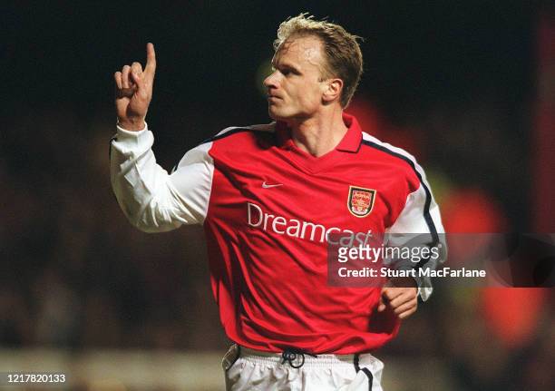 Dennis Bergkamp celebrates scoring a goal for Arsenal during the UEFA Champions League Group C match between Arsenal and Olympic Lyonnais on February...