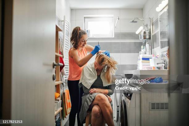 daughter dying her mother's hair at home - hair coloring stock pictures, royalty-free photos & images