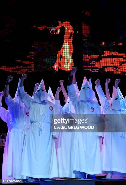 Members of the Ku Klux Klan dance ensemble rehearse for "Jerry Springer The Opera" at the Sydney Opera House on April 21, 2009. Following success in...